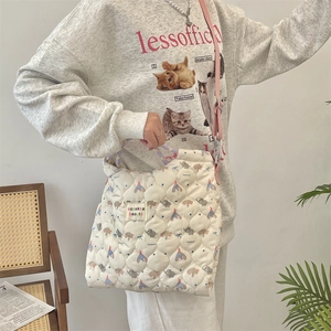 Detail of quilted canvas crossbody bag with cartoon print and adjustable strap