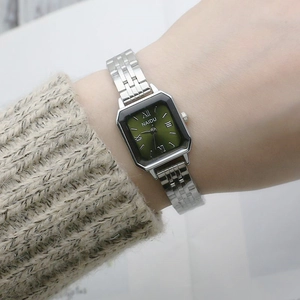Square silver quartz watch with green gradient dial and metal chain strap on wrist