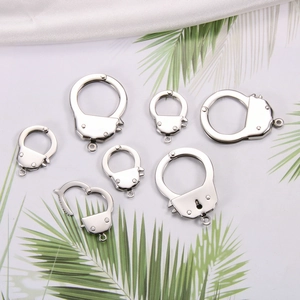 Detailed view of stainless steel handcuff charms in various sizes for DIY jewelry making