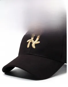 Close-up of golden letter embroidery on a structured black baseball cap for men