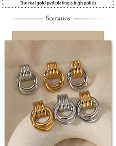 Detail view of gold and silver interlocked knot earrings with high polish pvd plating finish