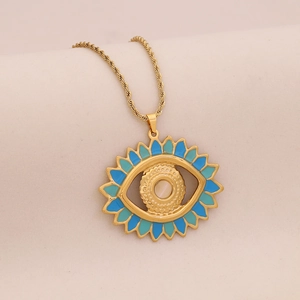 Golden evil eye necklace with blue enamel and white shell inlay on a twisted chain