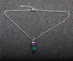 Macro detail of hexagonal prism gemstone pendant with purple to green gradient color