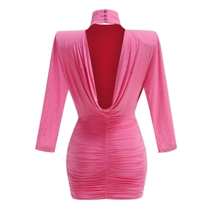 Detail of pink rhinestone mini dress featuring a backless design and high neck closure