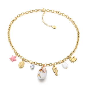 Gold stainless steel ocean necklace featuring seahorse, crab, and shell charms on white base