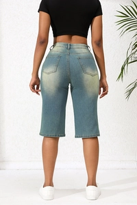 Detail view of the back of women's blue denim shorts showing pockets and waist tailoring