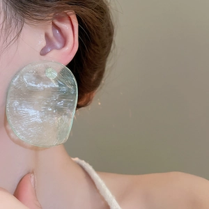 Detail showing irregular oval resin earring with ice crack texture on model side profile