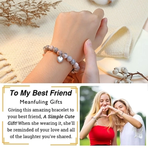 Detail of beaded friendship bracelet with a silver heart charm and gift card for best friend