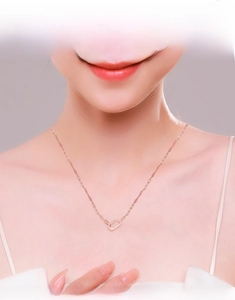 Close-up of elegant rose gold necklace with rectangular pavé-set crystal pendant on model