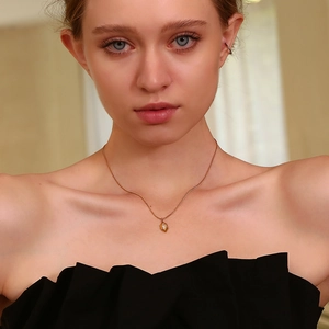 Close-up of 18K gold plated rhombus necklace with marquise diamond on model