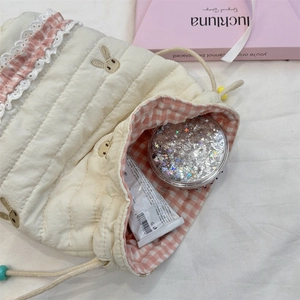 Quilted cosmetic drawstring bag with rabbit embroidery and pink lace details