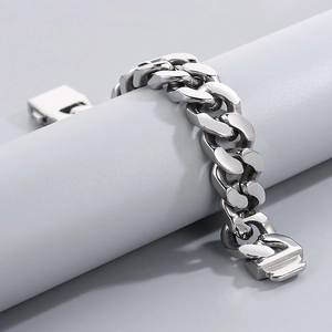 Macro view of 20mm thick polished stainless steel Cuban link bracelet with box clasp