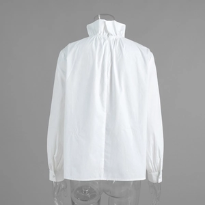 Detail view of ruffle stand collar and back zipper on white long sleeve blouse