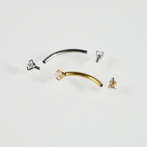 Disassembled stainless steel eyebrow rings in gold and silver with cubic zirconia stones