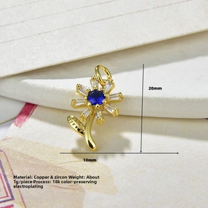 Detail of sunflower pendant featuring blue center zircon and 18K gold plated copper petals