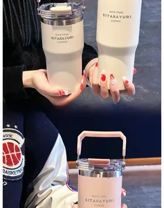 Detail of insulated coffee mug handles and transparent lids in cream and pink colors