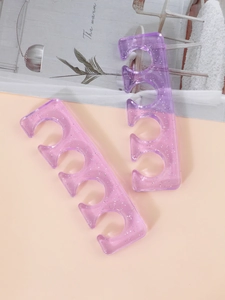 Detail of soft glittery purple gradient silicone toe separators for professional pedicures
