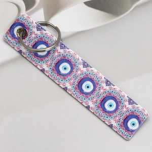 Macro shot of faux leather evil eye keychain charms with silver metal rings