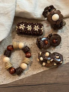 Close-up of bohemian stretch bracelets featuring coconut shells and wooden beads in earthy tones
