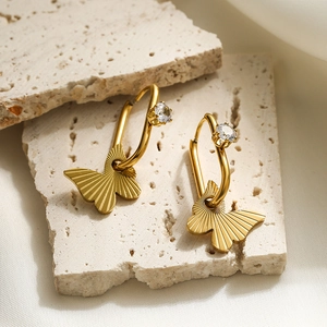 Gold titanium steel hoop earrings with butterfly pendants and clear zircon stones