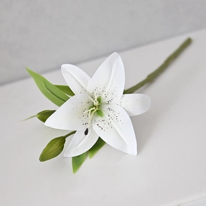 Macro detail of white artificial lily petals and bud with natural texture on a flat base