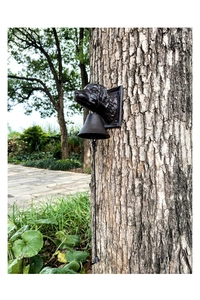 Detailed macro view of an antique cast iron doorbell featuring a classic dog head sculpture