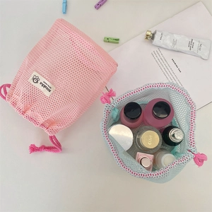 Close-up of pink and blue mesh drawstring storage bags with breathable grid fabric