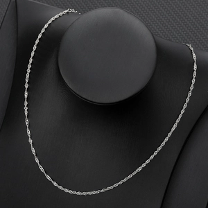 Close-up of a silver twisted curb chain necklace displayed on a black velvet bust