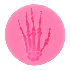Macro shot of pink silicone fondant mold featuring detailed skeleton hand pattern