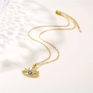 Golden necklace featuring a crown and evil eye pendant set with sparkling cubic zirconia