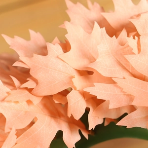 Pink Christmas wreath with lifelike maple leaves for romantic holiday door decoration