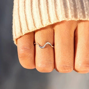 Minimalist S925 sterling silver wave ring with sparkling zircons worn on finger
