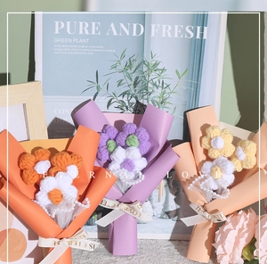 Detail of handmade knit puff flower bouquet with pearl chain and LOVE printed ribbon