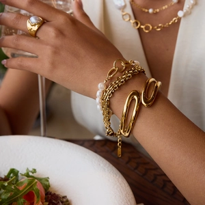 Elegant 18K gold-plated stainless steel pearl jewelry set worn by a fashion model
