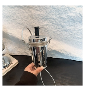 Detailed view of silver milk tea cup bag with black straw and metallic finish