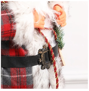 Detailed close-up of a Santa Claus doll with red plaid fabric and white plush trim