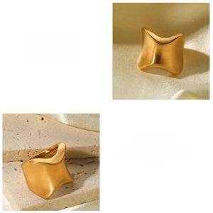 Macro view of golden irregular curved titanium steel ring with brushed metal texture