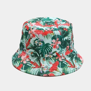 Detailed pattern of flamingo and tropical floral print on mint green bucket hat