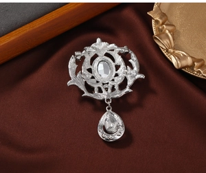 Detail view of the silver vintage brooch back showing the secure safety pin and clasp