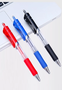 Close-up of red, blue, and black retractable gel pens with comfortable rubber grips on a laptop