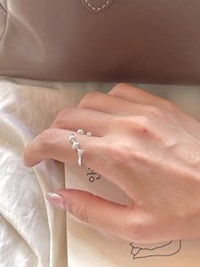 Detail of adjustable 925 sterling silver irregular ring with polished wavy surface