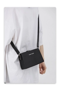 Close-up of black crossbody box bag showing silver metal hooks and CONE KNOWS logo