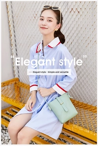 Detail of mint green crossbody bag featuring a gold buckle and elegant strap on a model