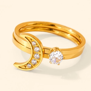 Detail view of gold moon ring featuring white zircon stones and round claw-set diamond