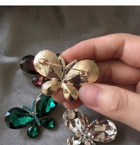 Detail view of the secure pin clasp and metal craft on a butterfly brooch