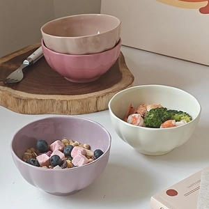 Set of four pastel ceramic petal-shaped bowls in beige, pink, purple, and light green