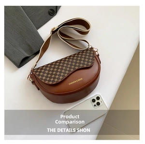 Detail of vintage brown saddle bag with geometric patterns and adjustable woven strap