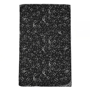 Detail of translucent black chiffon scarf featuring white musical note patterns and texture