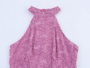 Detail of mauve halter dress featuring textured floral fabric and a hidden back zipper