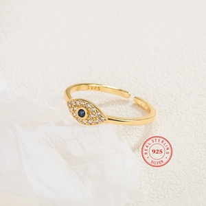 Macro detail of gold S925 sterling silver evil eye ring with blue stone and S925 stamp